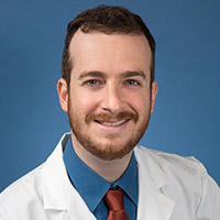 A headshot of Guy Weiss.